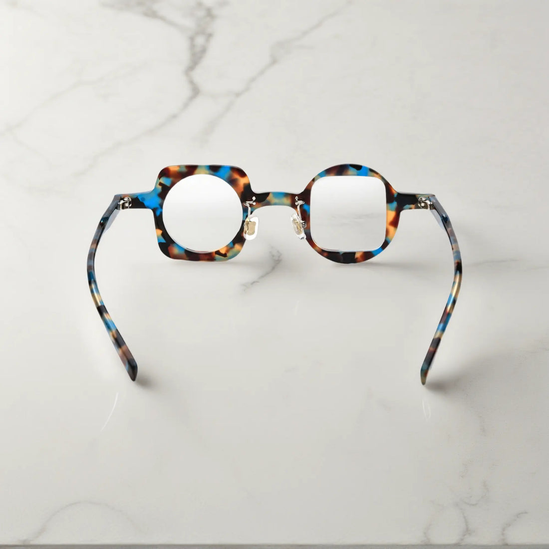 Back view highlighting the blue tortoise colorway of VoyueLens asymmetrical glasses with comfortable silicone pads and sturdy hinges.