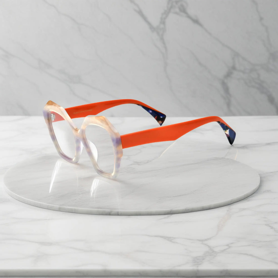 Side profile showing playful orange acetate temples and bright eye-catching tones.