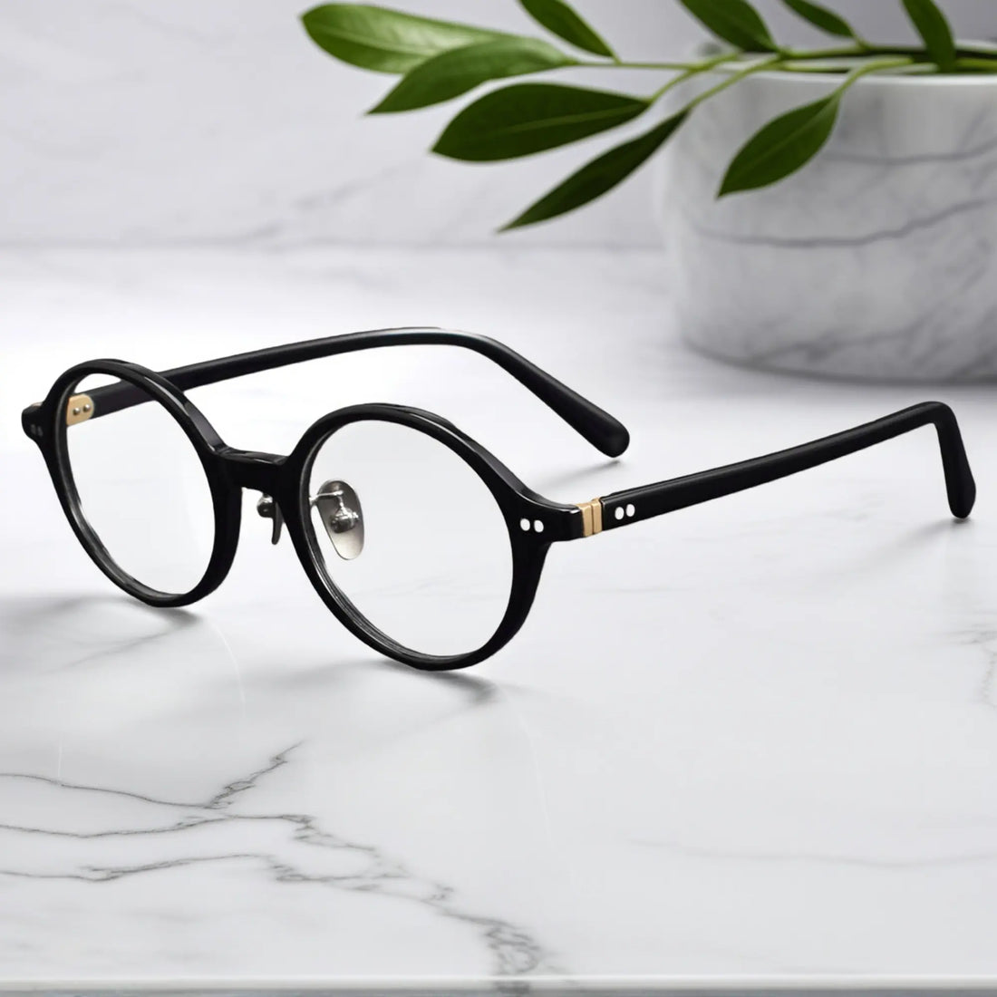 Black round eyeglasses showing titanium nose pads and metal-insert hinges