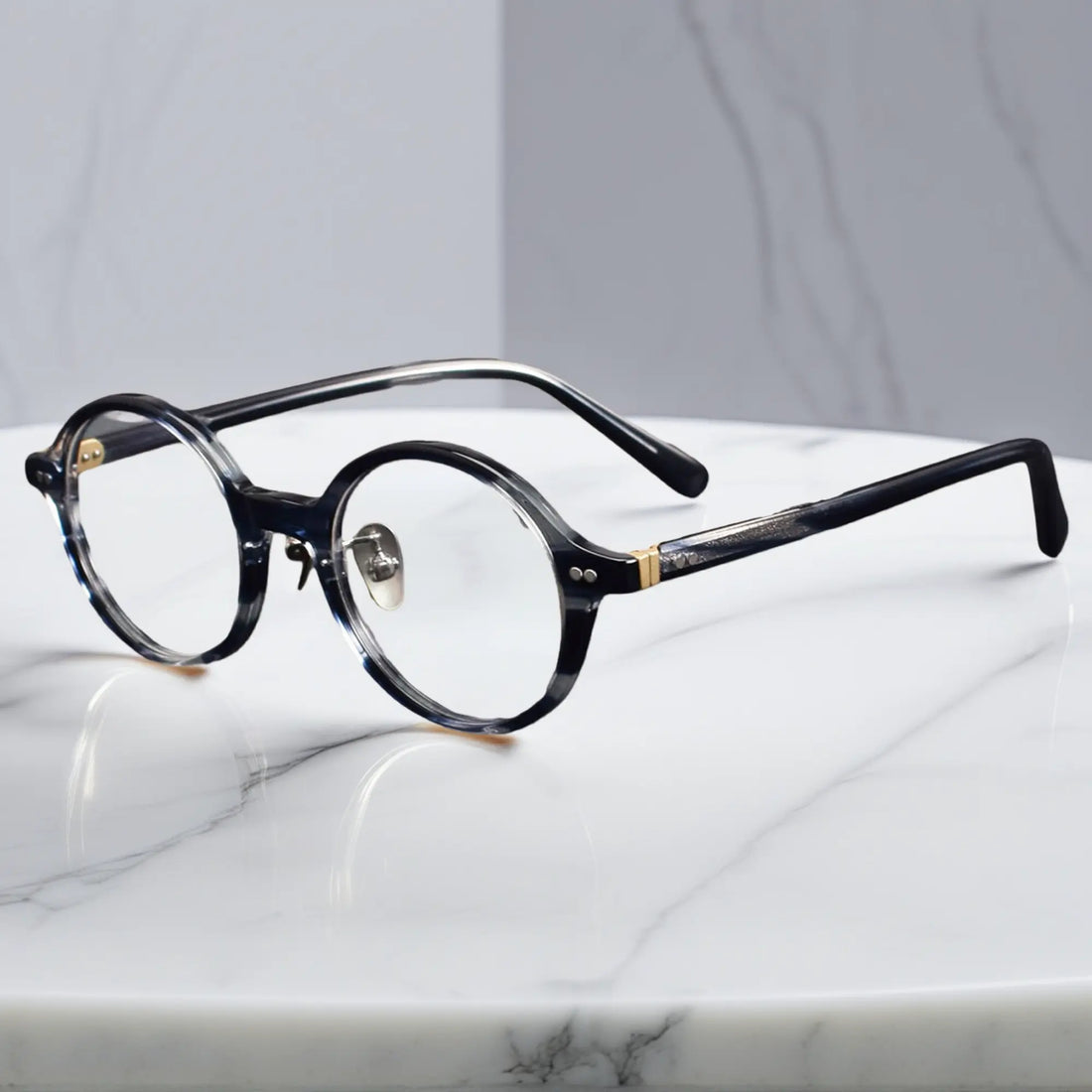 Blue Tortoise round eyeglasses showing titanium nose pads and metal-insert hinges