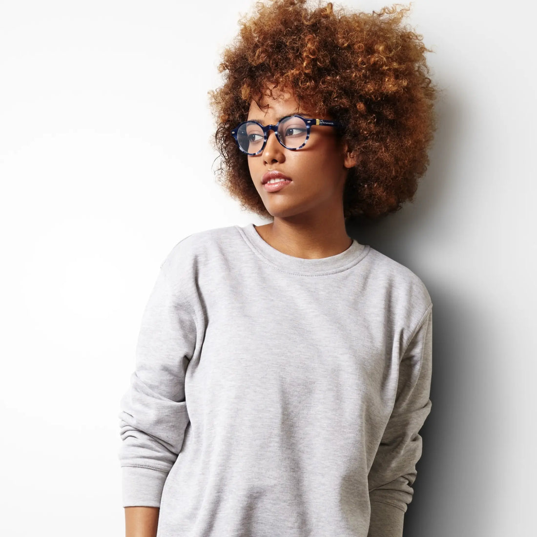 Person wearing VoyueLens round glasses in office