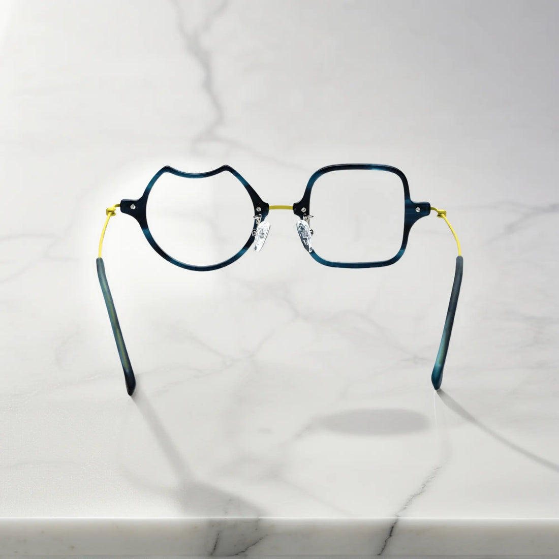 Back View of VoyueLens™ Electric Olive bold abstract eyeglasses VL185842-C5. Rear view displaying the acetate frame and the titanium temple connection structure.