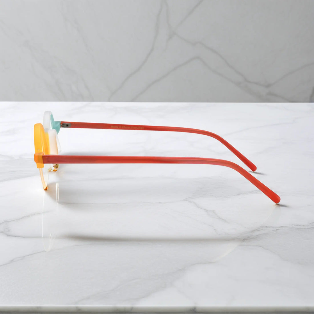 Side view showcasing VoyueLens™ Ivory-Orange matte acetate semi-rimless browline eyeglasses with lightweight design and red temples