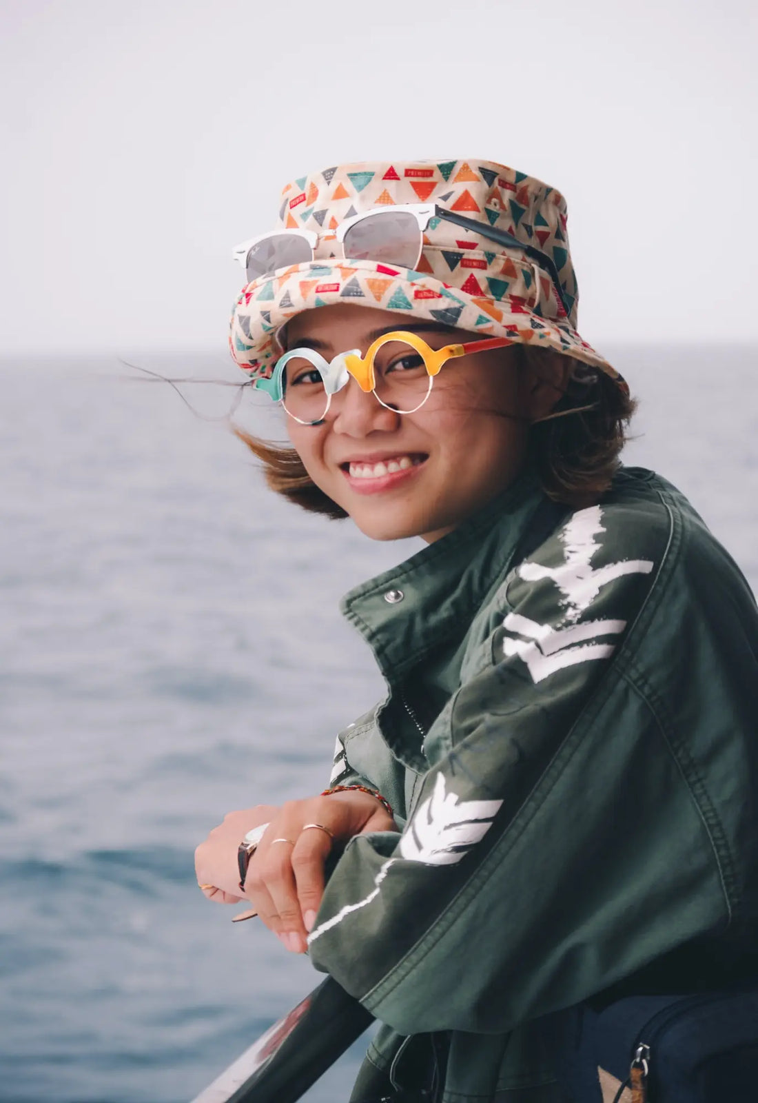 Outdoor model wearing VoyueLens™ Ivory-Orange semi-rimless browline eyeglasses, demonstrating stylish matte frame fit.