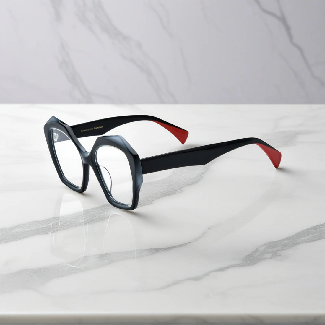Side view displaying black acetate temples with red tips for a bold, modern twist.