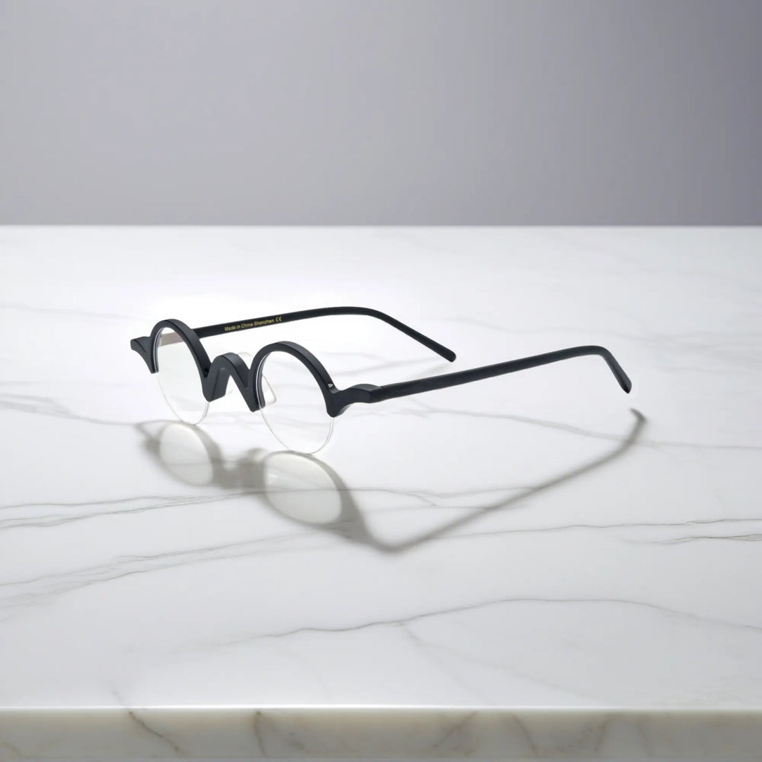 Side look at VoyueLens™ Solid Black semi-rimless browline eyeglasses, focusing on bold black matte acetate frame.