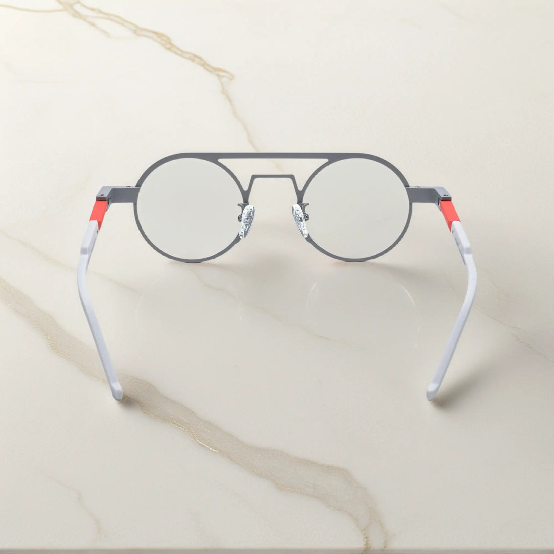 Rear angle displaying the ergonomic nose pads and lightweight design in Chrome Ember sleek silver titanium frame with a subtle industrial edge