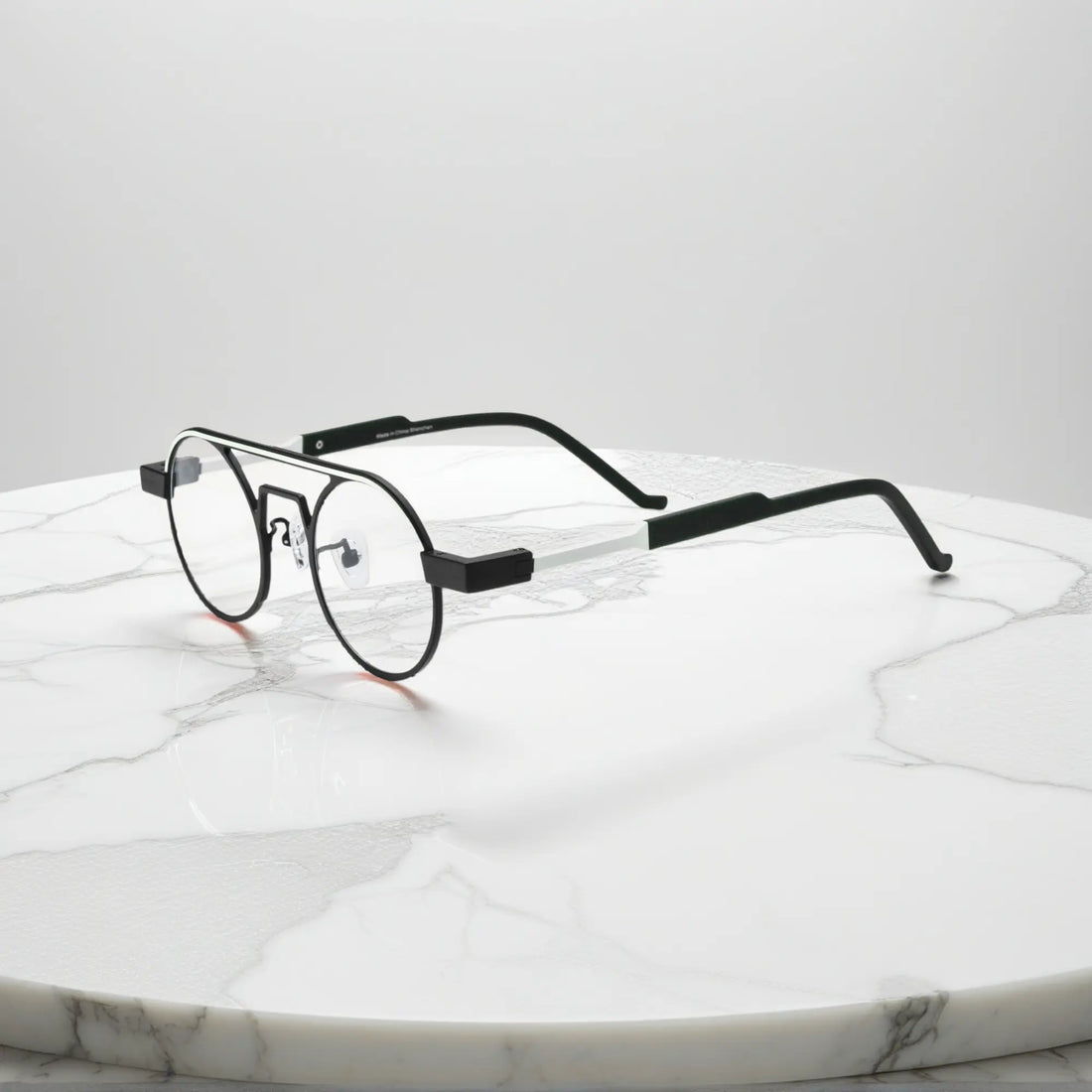 Side profile showing the slim titanium arms and hinge structure in Graphite Black matte titanium frame for a modern minimalistic look