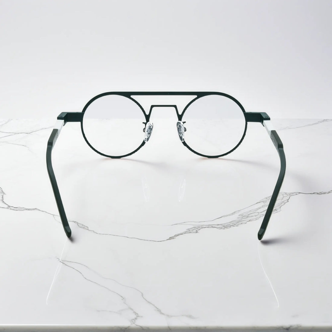 Rear angle displaying the ergonomic nose pads and lightweight design in Urban Ink deep green-gray combination for sophisticated style