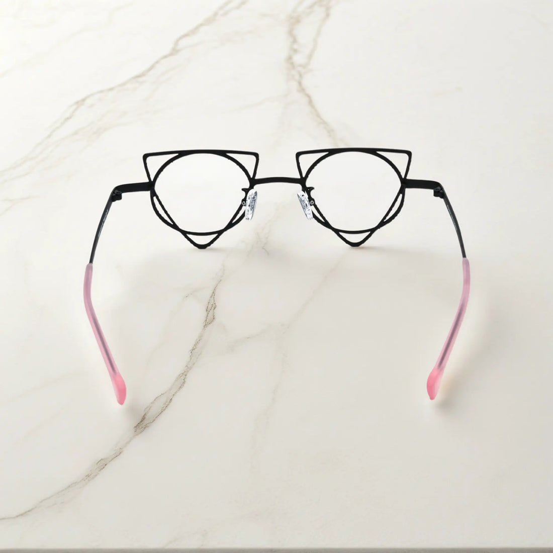 Back angle revealing artistic frame curves of VoyueLens™ Matte Black geometric glasses, crafted from lightweight titanium