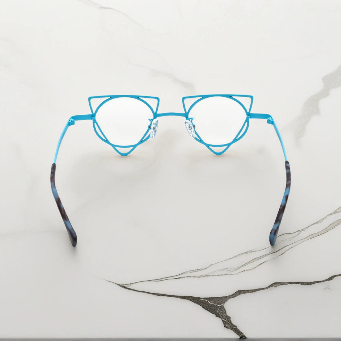 Back angle revealing artistic frame curves of VoyueLens™ Tangerine Blue geometric glasses, crafted from lightweight titanium