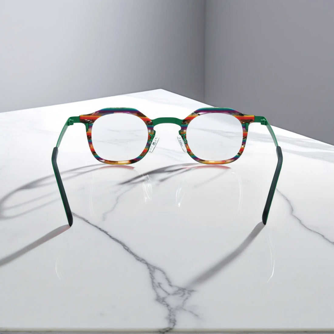 Rear view of VoyueLens™ Aurora Stripe eyeglasses showing a green-to-clear gradient acetate front and satin titanium temples.