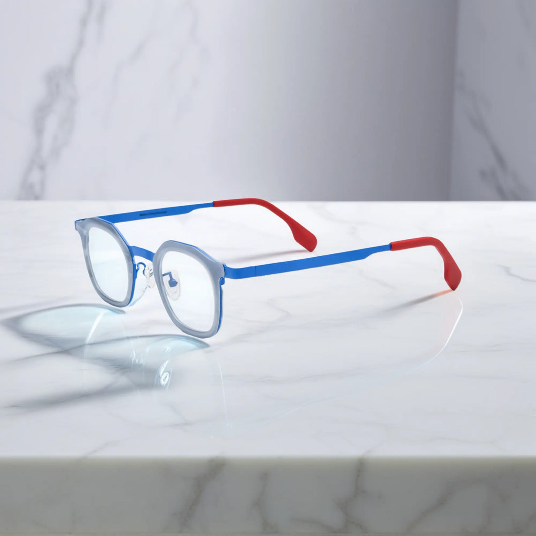 Side view of VoyueLens™ Ocean Signal square eyeglasses a deep blue acetate front and vibrant red titanium temples.