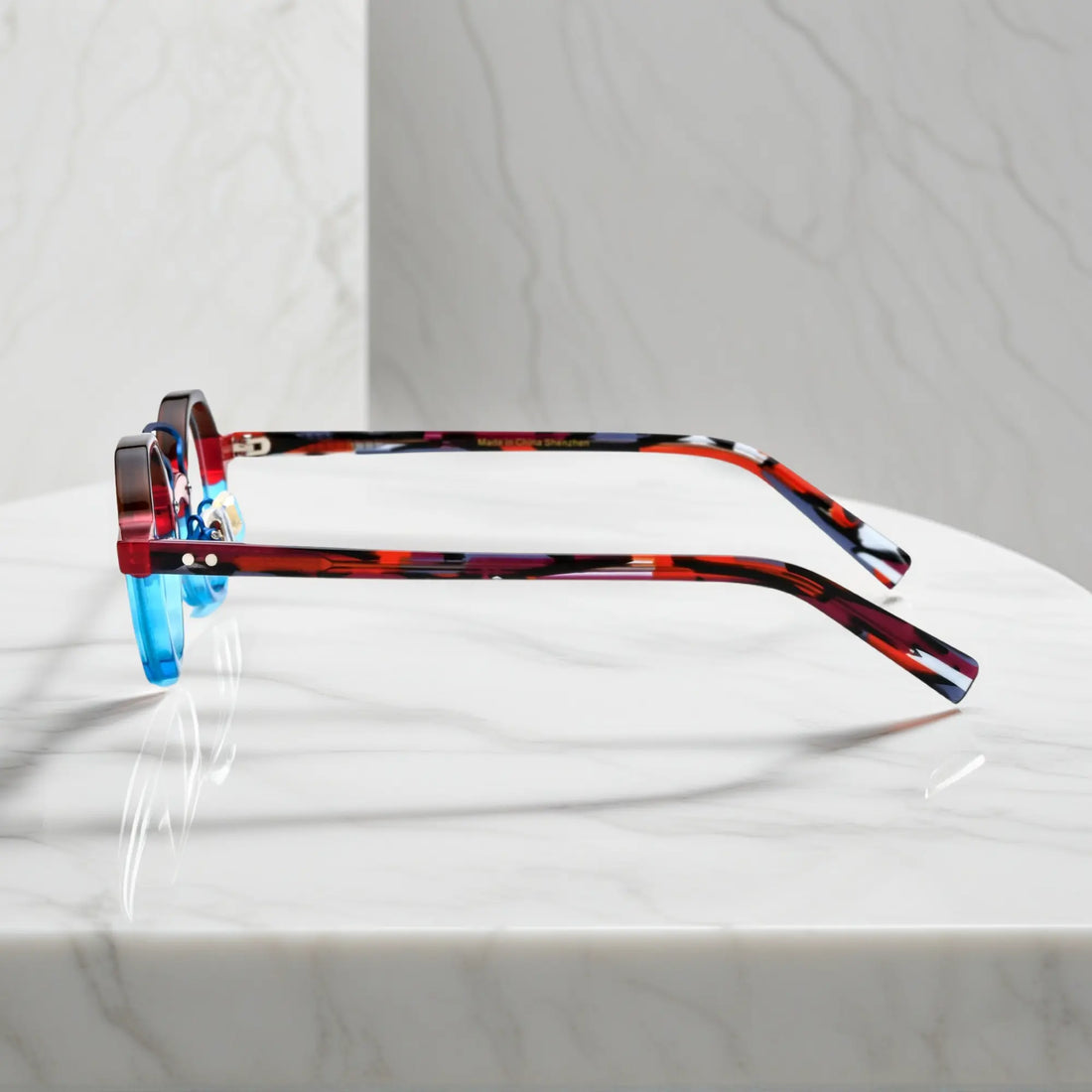 Side profile of VoyueLens™ VL19244 unisex acetate eyeglasses in bold Crimson Blue Fusion for petite faces.Red tortoise shell temples