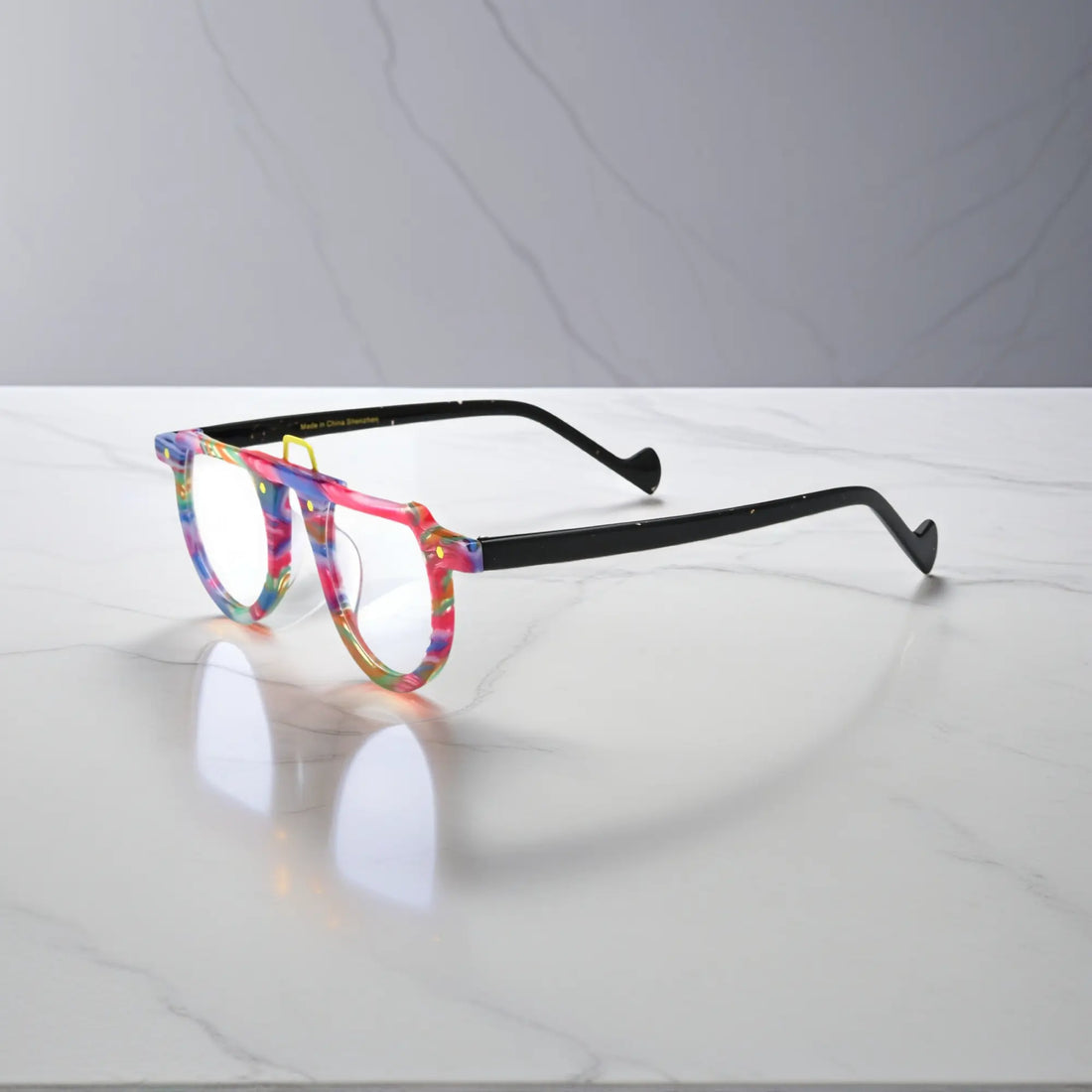 Side profile of Rainbow Rush glasses – bold acetate colors with a playful design