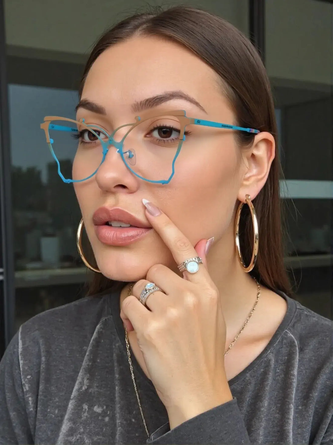 VoyueLens™ cat-eye eyeglasses in yellow and blue frame, worn by a woman with hoop earrings, showing bold retro-futuristic style – SKU VL185862.