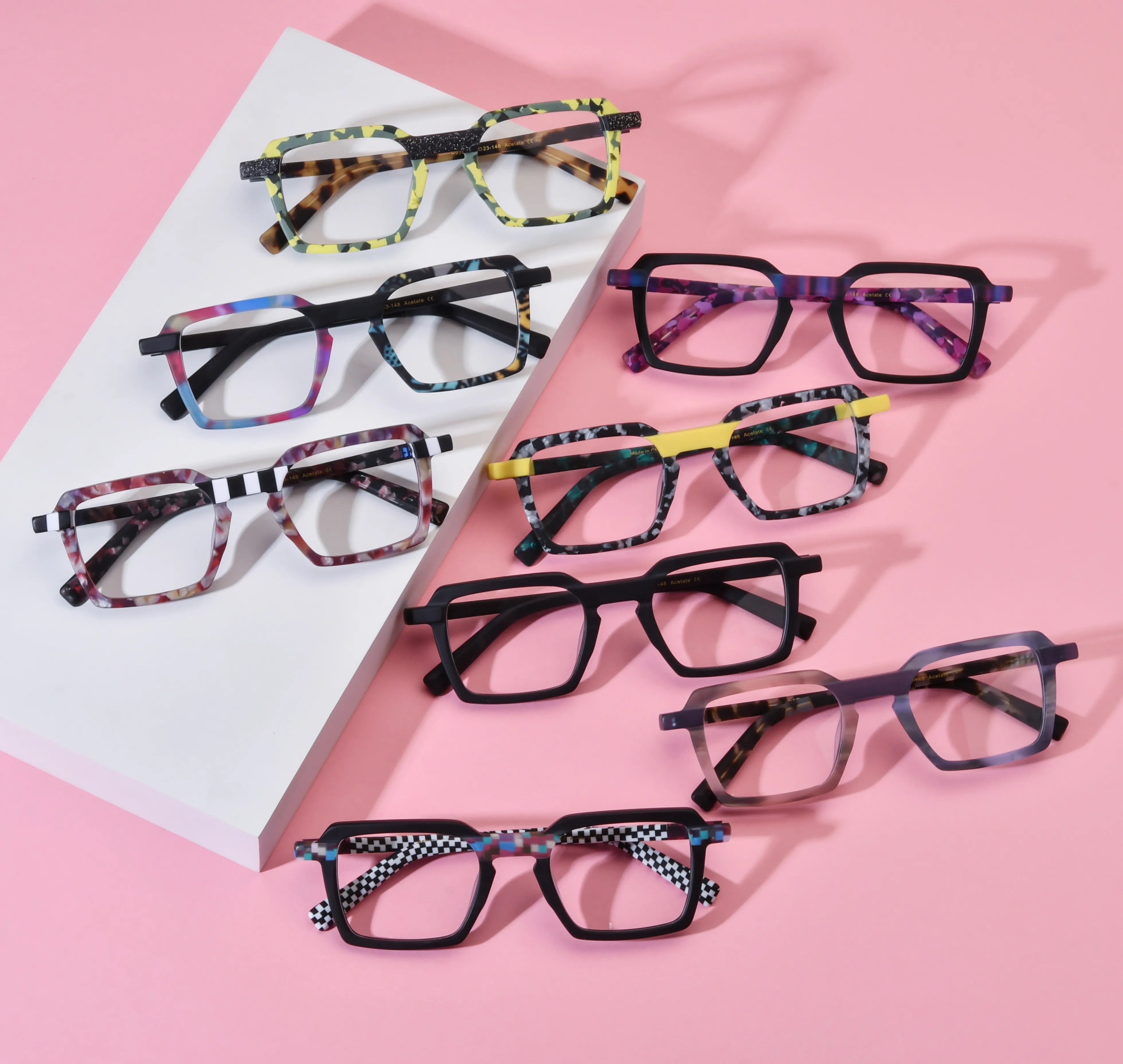 Barledear patchwork acetate square eyeglasses lifestyle group image showing all eight colorful frame variants on a pink background