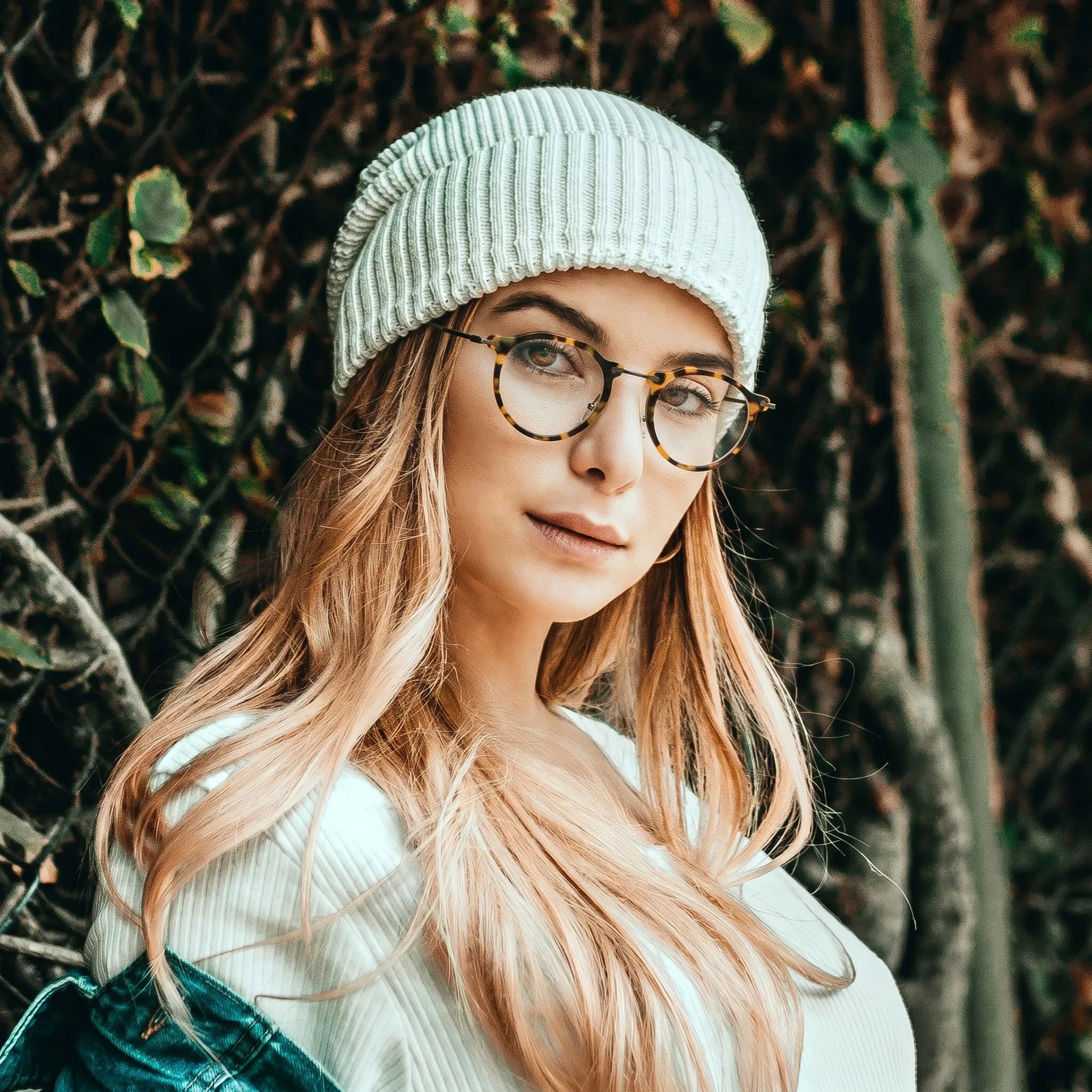 Model wearing Barledear Amber Leopard eyeglasses in a lifestyle portrait showing the retro oval acetate metal frame