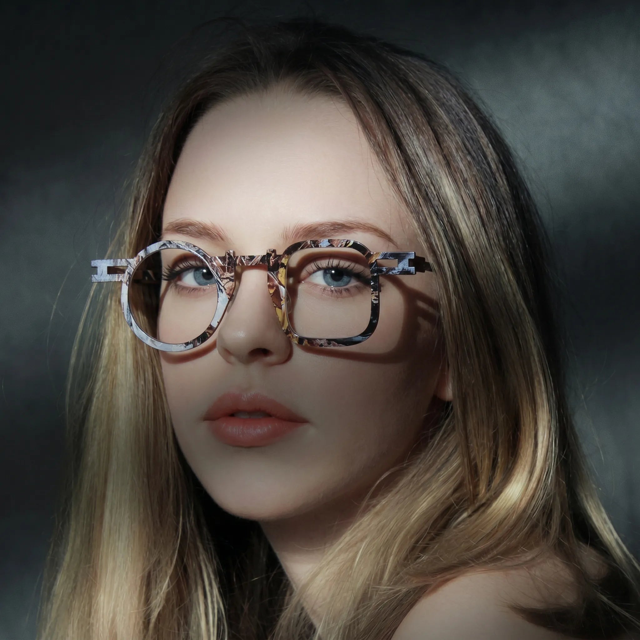 Model wearing Barledear Amber Mosaic Brown eyeglasses in a lifestyle portrait with asymmetric geometric titanium frame