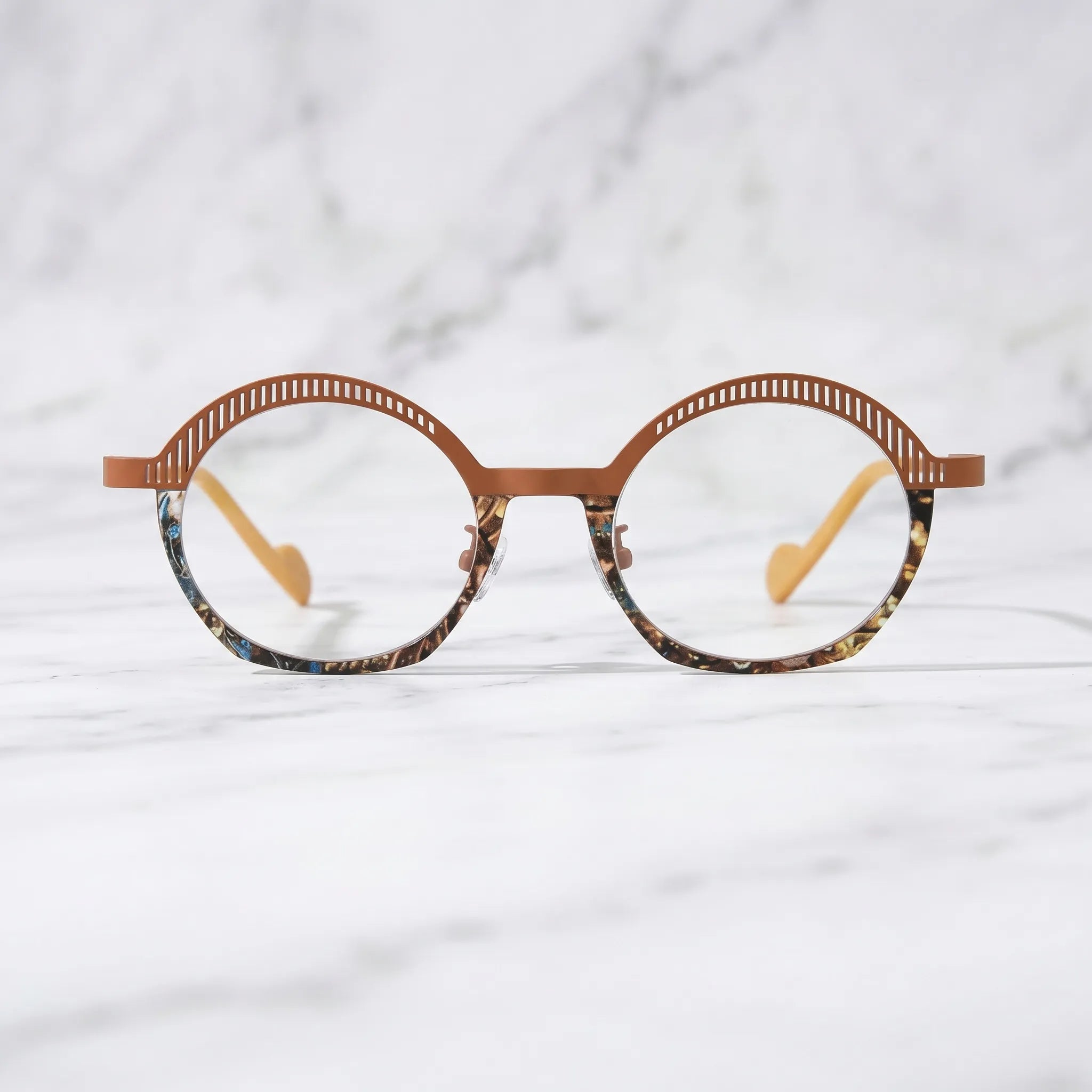 Barledear Amber Mosaic eyeglasses shown in a clean lifestyle front view with amber brown titanium browline and patterned lower rim