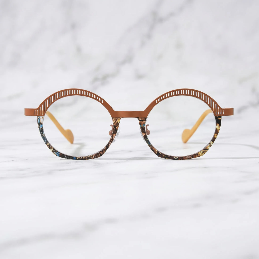 Barledear Amber Mosaic eyeglasses shown in a clean lifestyle front view with amber brown titanium browline and patterned lower rim