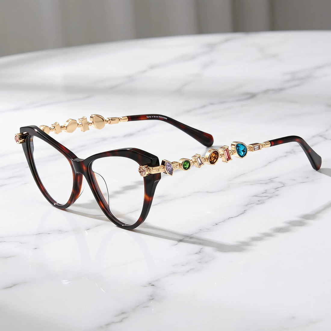 Barledear Amber Tortoise eyeglasses angled side view highlighting multicolor geometric crystal accents along the gold-tone temples