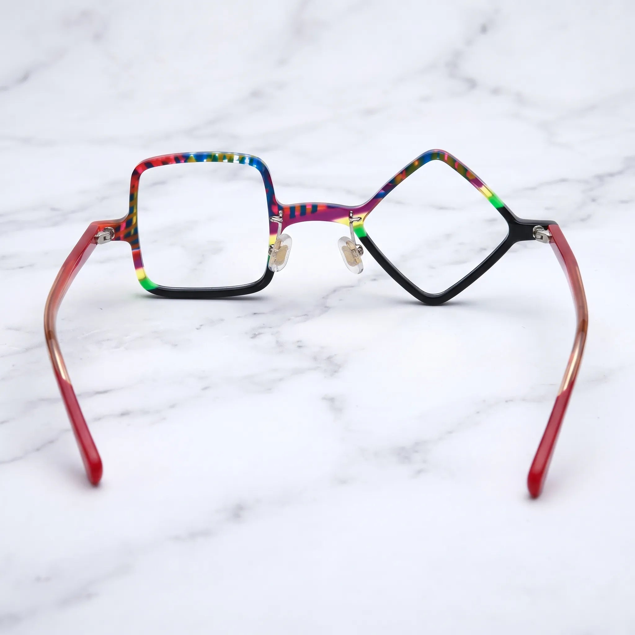 Barledear Carnival Noir asymmetric geometric acetate eyeglasses back view showing the black lower rims, adjustable nose pads, and red temple structure.