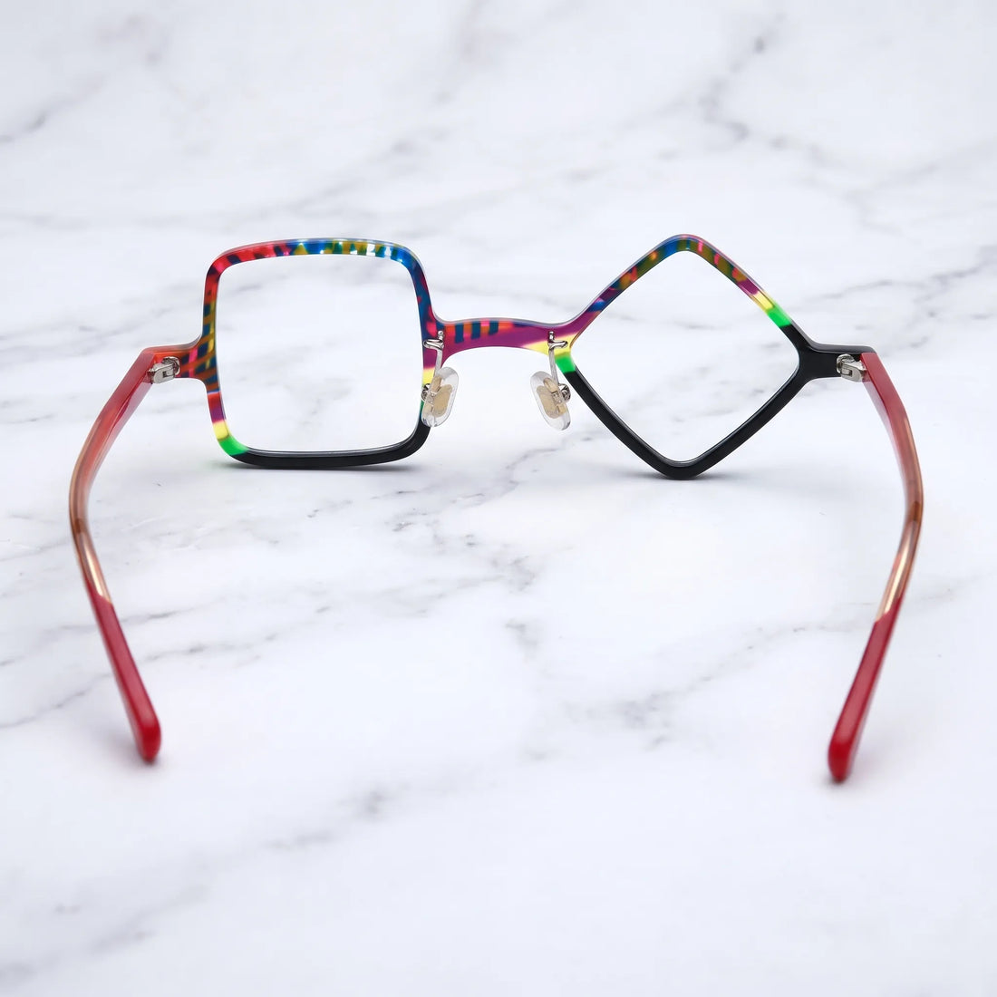 Barledear Carnival Noir asymmetric geometric acetate eyeglasses back view showing the black lower rims, adjustable nose pads, and red temple structure.