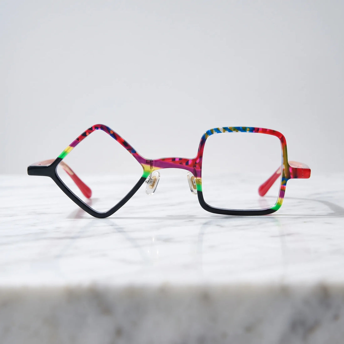 Barledear Carnival Noir asymmetric geometric acetate eyeglasses shown in a clean lifestyle front display with vibrant color blocking and black contrast details.