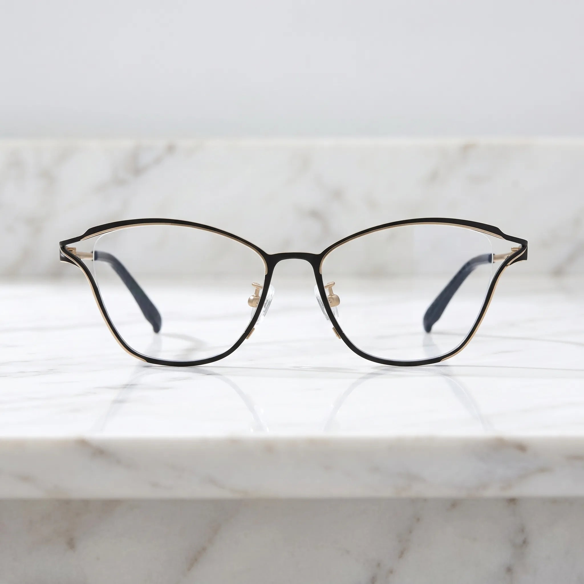 Barledear Champagne Noir eyeglasses shown in a clean lifestyle front view with black and champagne titanium frame detail