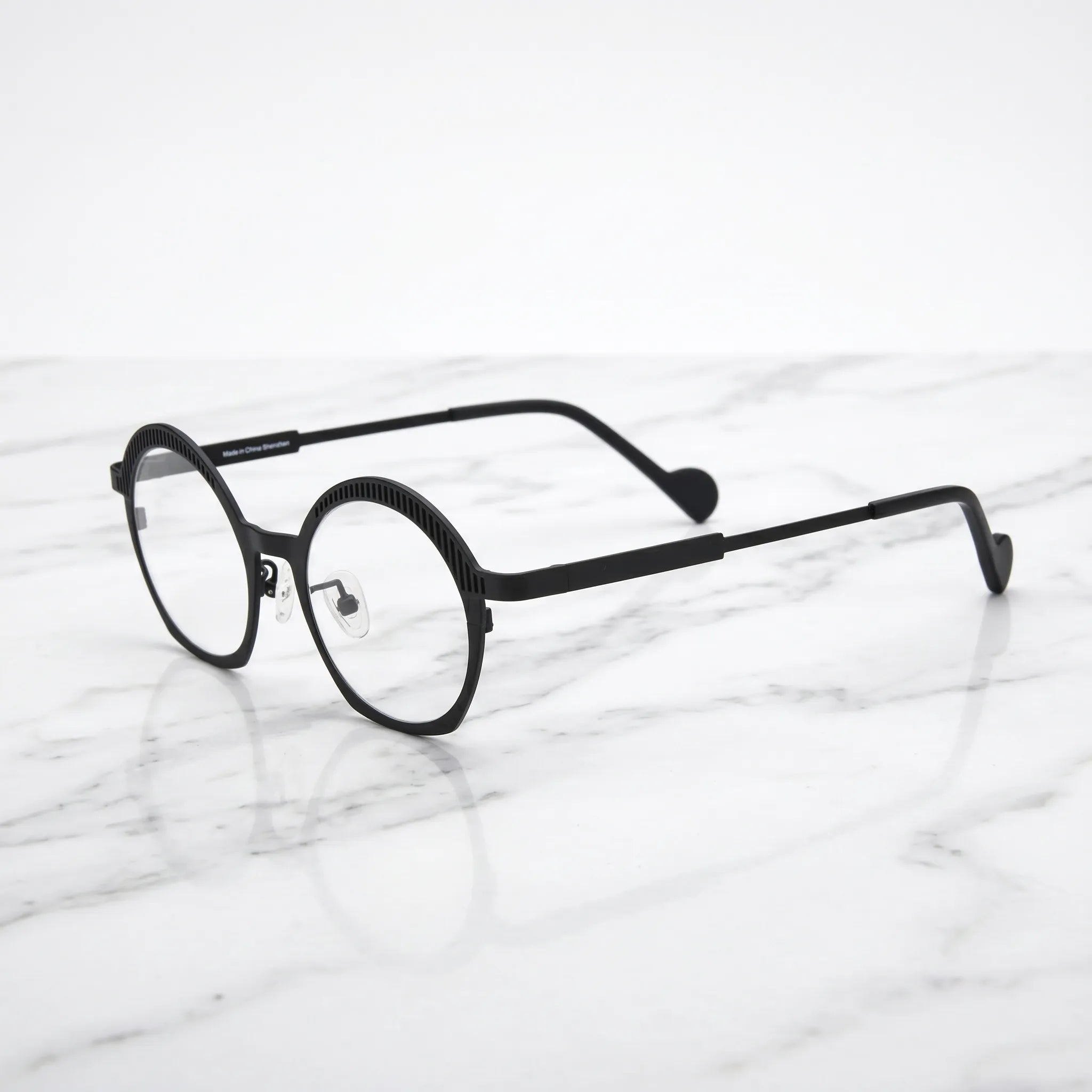 Barledear Charcoal Black eyeglasses angled side view showing slim titanium temples, curved black temple tips, and decorative slotted browline