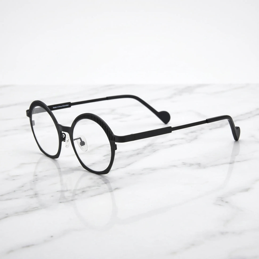 Barledear Charcoal Black eyeglasses angled side view showing slim titanium temples, curved black temple tips, and decorative slotted browline