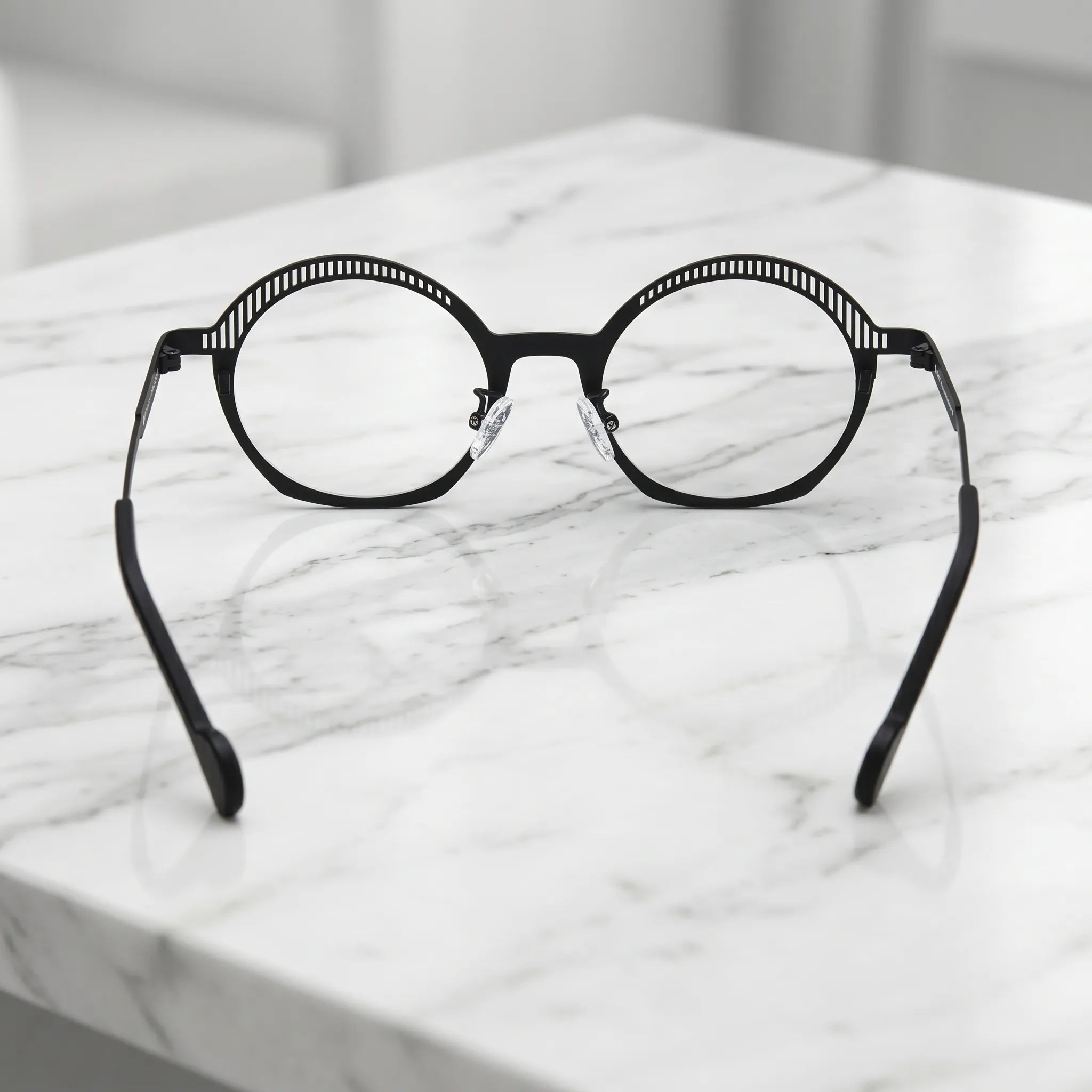 Barledear Charcoal Black eyeglasses back view showing adjustable clear silicone nose pads and prescription-ready titanium frame structure