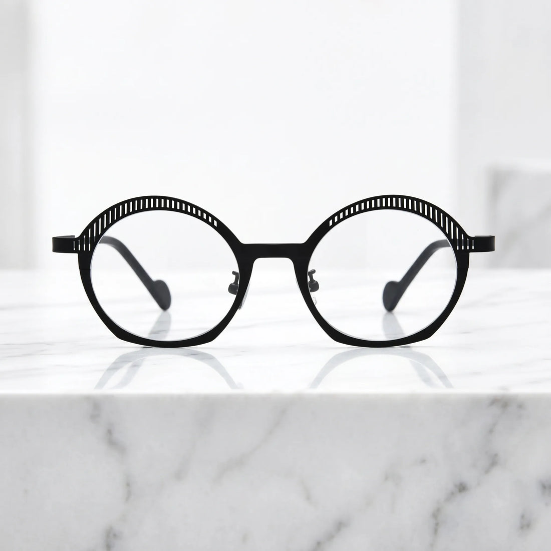 Barledear Charcoal Black eyeglasses shown in a clean lifestyle front view with minimalist black titanium frame and geometric oval shape