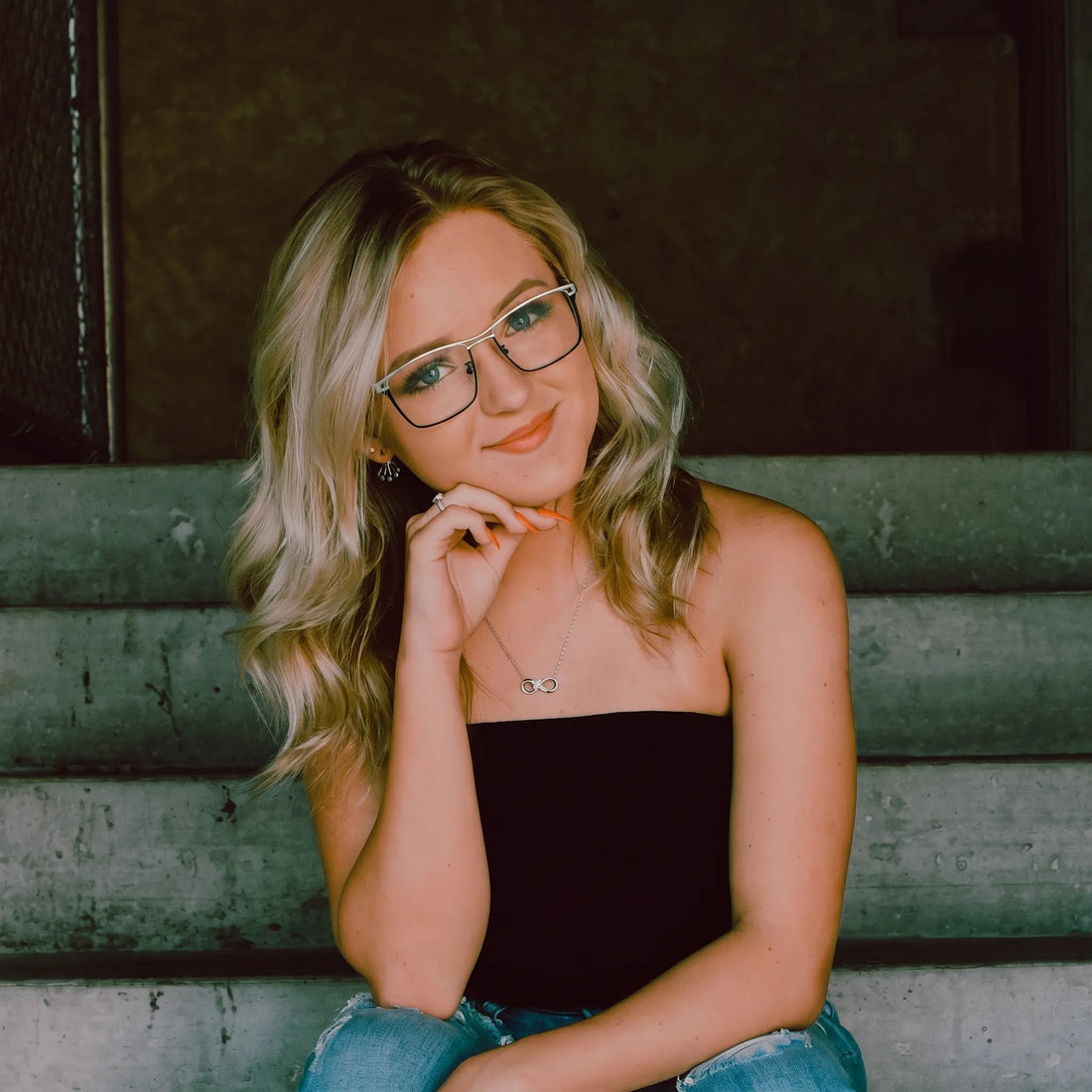 Model wearing Barledear Checkerboard Ivory Black eyeglasses with geometric square titanium frame in a lifestyle portrait