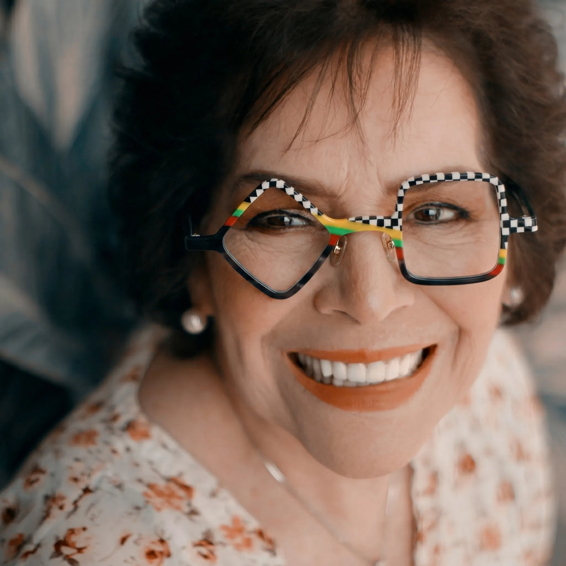 Adult model wearing Barledear Checkerboard Spectrum asymmetric geometric acetate eyeglasses in a bold modern street-style portrait.