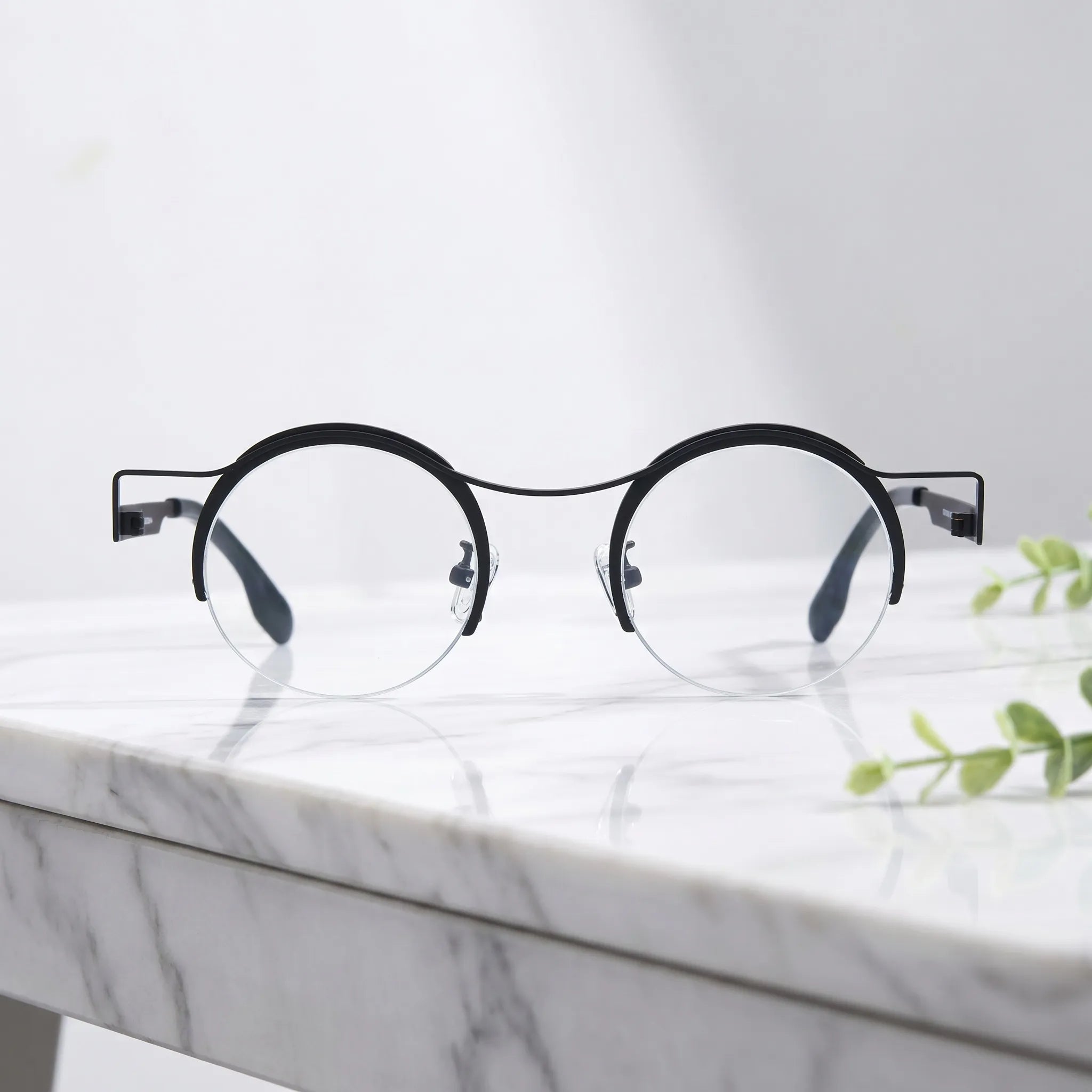 Barledear Classic Noir eyeglasses shown in a clean lifestyle front view with minimalist retro round titanium frame