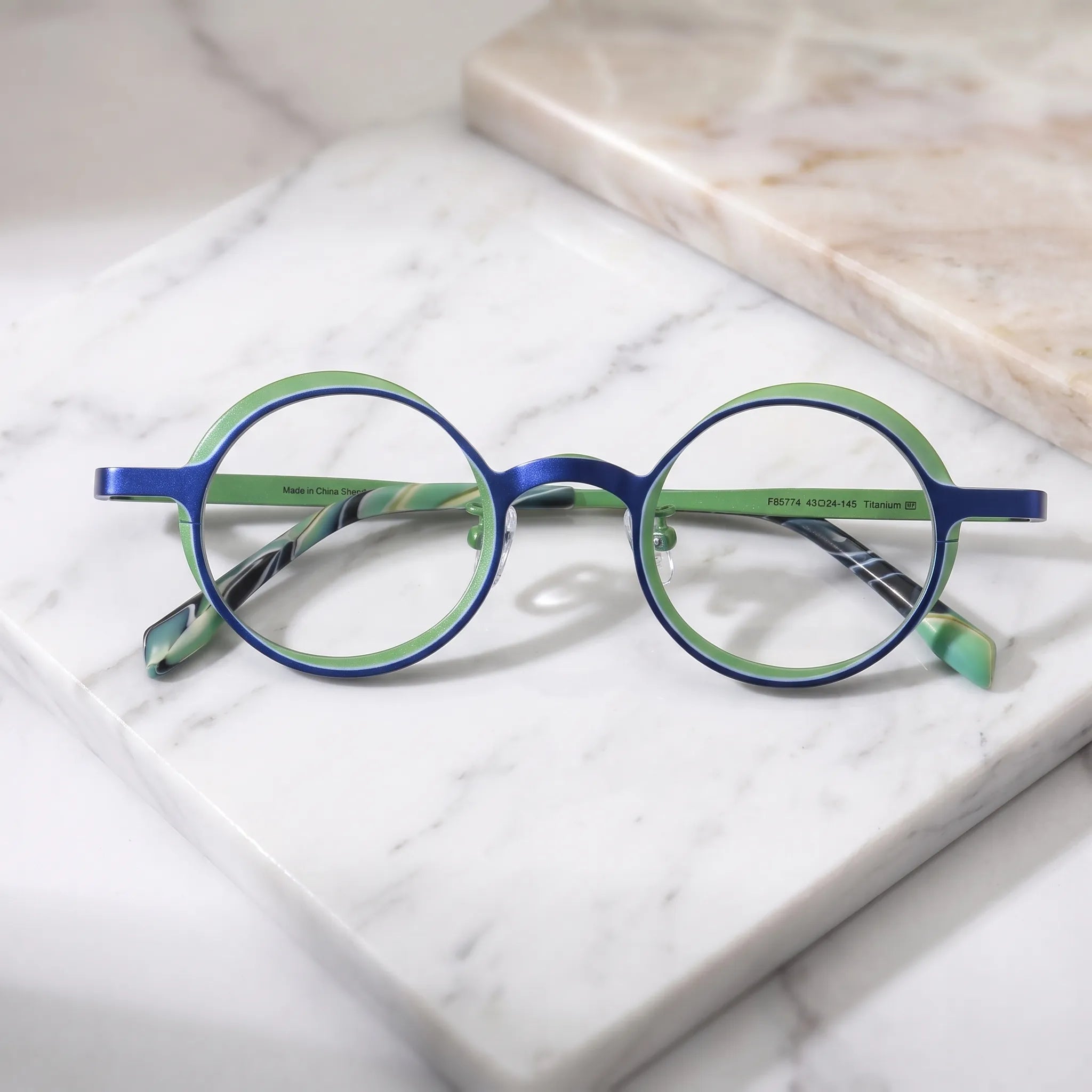 Barledear Cobalt Jade round pure titanium eyeglasses folded display showing slim temples patterned temple tips and adjustable nose pads