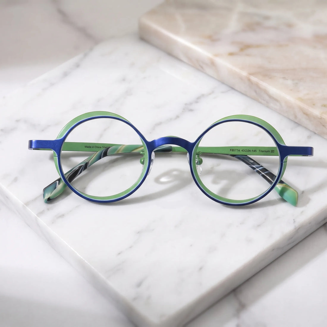 Barledear Cobalt Jade round pure titanium eyeglasses folded display showing slim temples patterned temple tips and adjustable nose pads