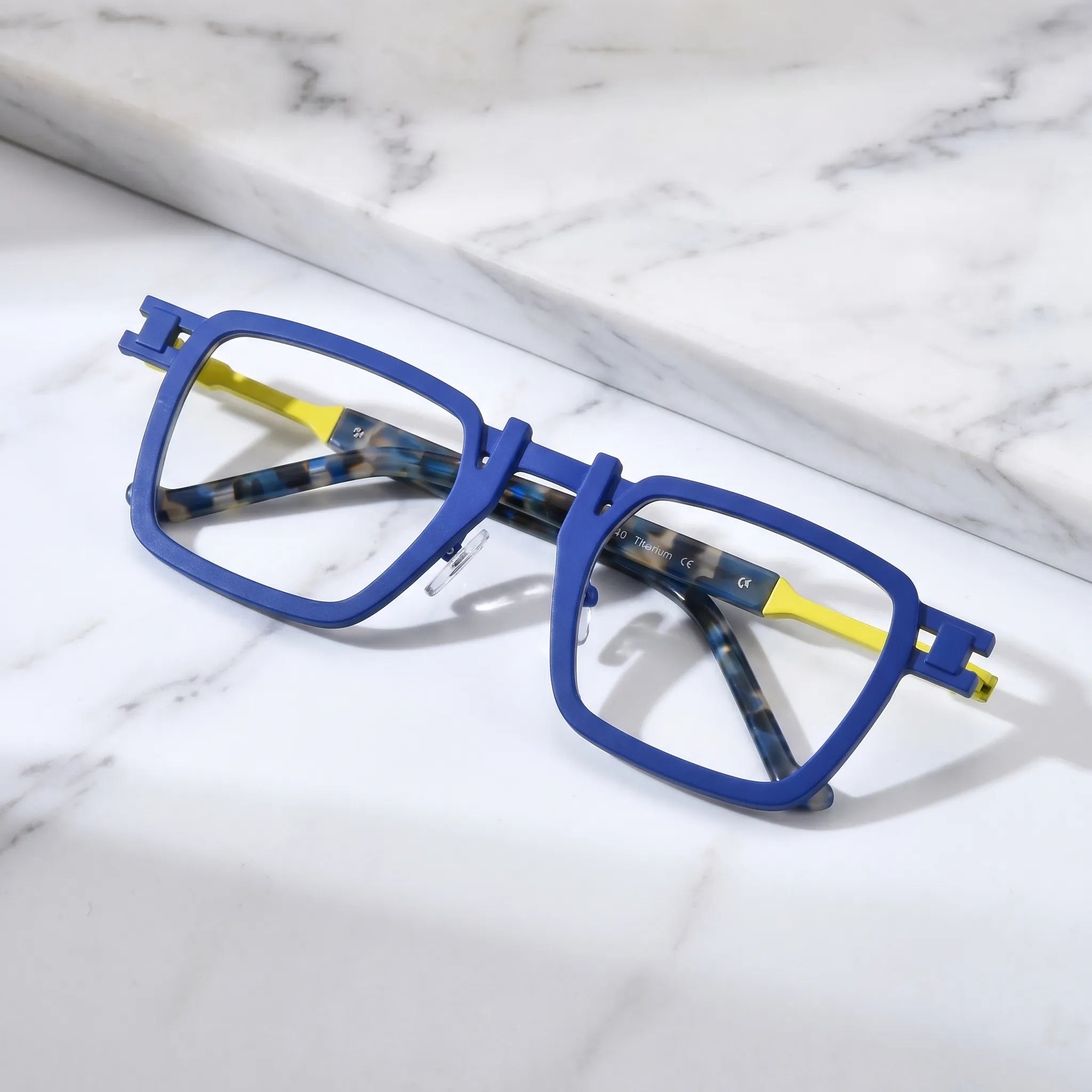 Barledear Cobalt Lemon Mosaic eyeglasses folded display showing pure titanium frame structure, patterned temple arms, and square full-rim design