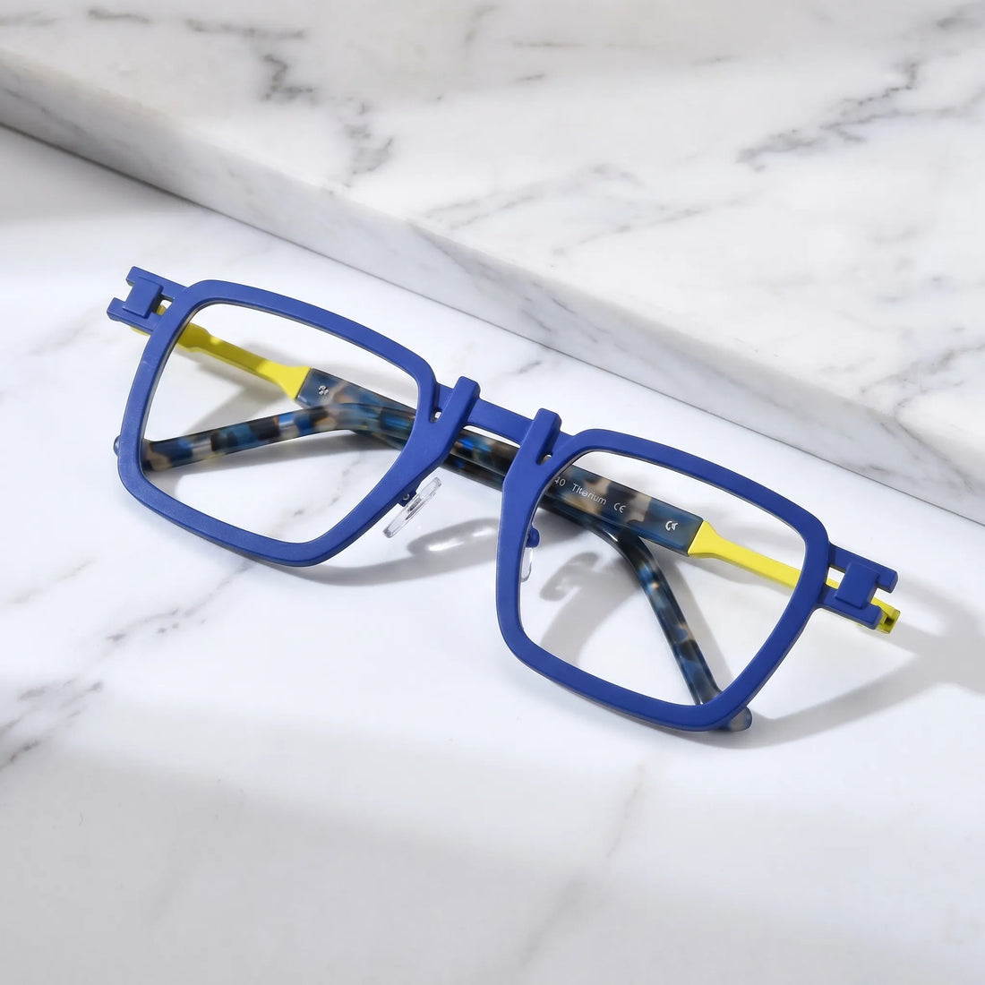 Barledear Cobalt Lemon Mosaic eyeglasses folded display showing pure titanium frame structure, patterned temple arms, and square full-rim design