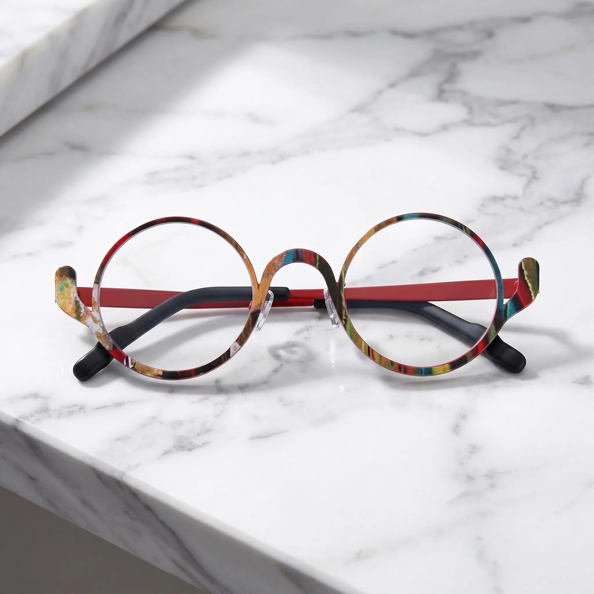 Barledear Crimson Artline eyeglasses folded display showing the round frame shape, slim temples, and artistic color-spliced pure titanium construction