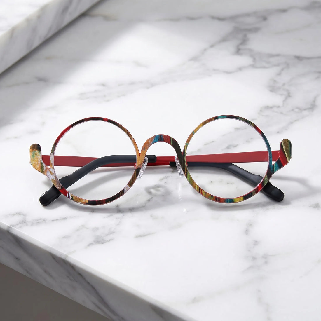 Barledear Crimson Artline eyeglasses folded display showing the round frame shape, slim temples, and artistic color-spliced pure titanium construction
