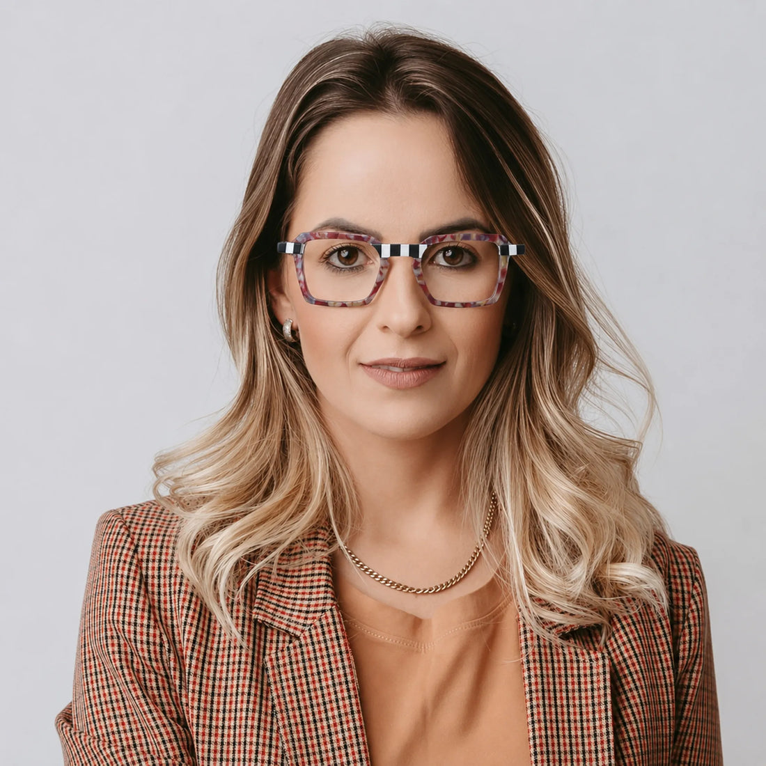 Model wearing Barledear Crimson Checker Bloom square eyeglasses in a bold lifestyle portrait