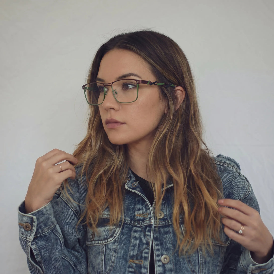 Model wearing Barledear Crimson Meadow Green eyeglasses with lightweight geometric titanium frame in a lifestyle portrait