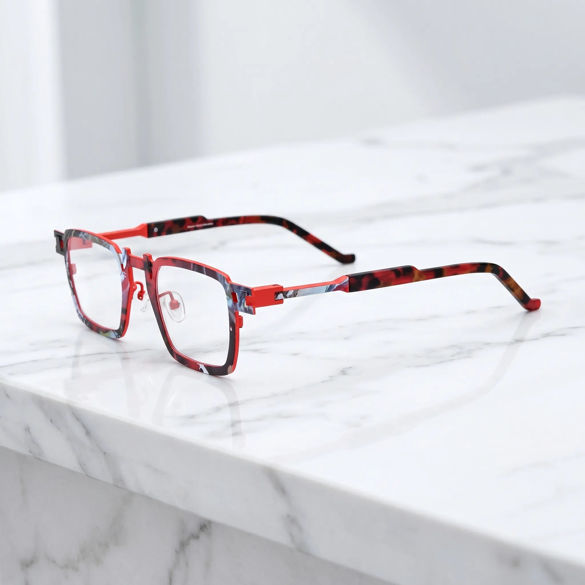 Barledear Crimson Noir Mosaic eyeglasses angled side view showing slim titanium temples, geometric side joint, and red colorblock detail
