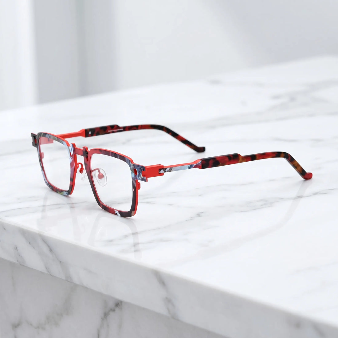 Barledear Crimson Noir Mosaic eyeglasses angled side view showing slim titanium temples, geometric side joint, and red colorblock detail