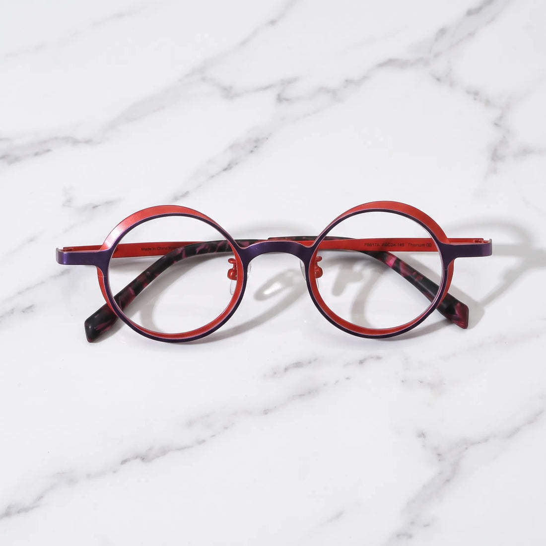 Barledear Crimson Violet round pure titanium eyeglasses folded display showing slim temples patterned temple tips and adjustable nose pads