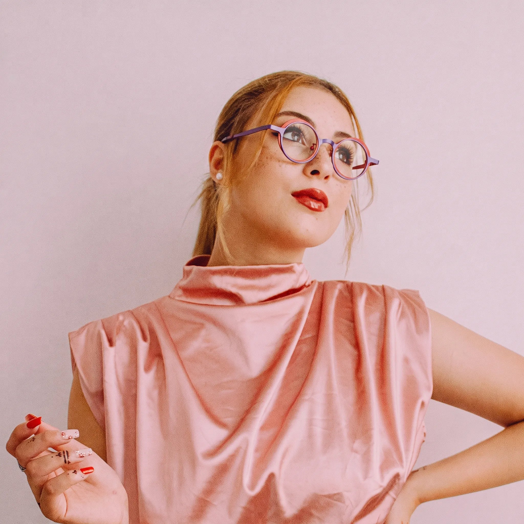 Model wearing Barledear Crimson Violet round pure titanium eyeglasses in a lifestyle portrait showing a lightweight design for everyday wear