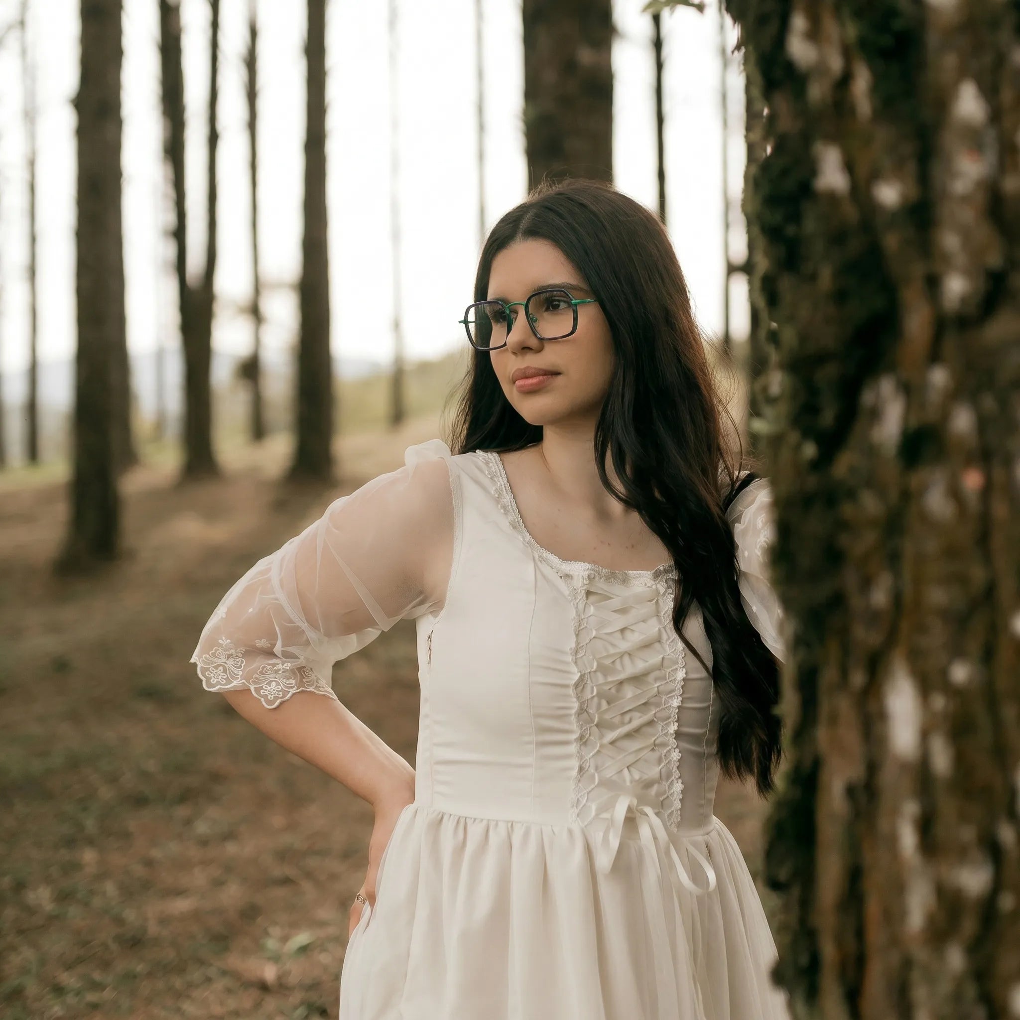 Model wearing Barledear Emerald Graphite Green eyeglasses in a lifestyle portrait